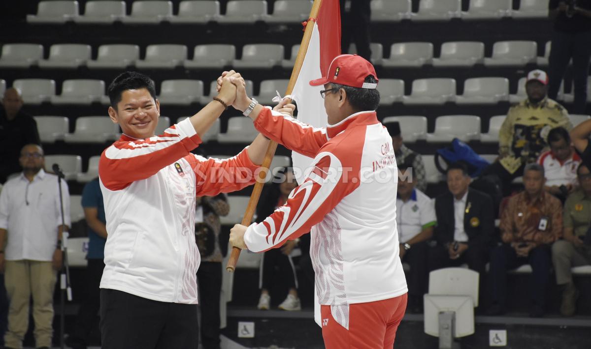 Raja Sapta Oktohari menyerahkan bendera Merah Putih. Bendera Indonesia dilarang dikibarkan di event resmi selama LADI mendapat sanksi WADA.