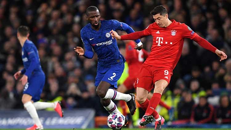 Striker Bayern Munchen, Robert Lewandowski (kanan) dijaga ketat oleh bek tengah Chelsea, Antonio Rudiger dalam pertandingan 16 besar Liga Champions 2019-2020 leg pertama di Stamford Bridge