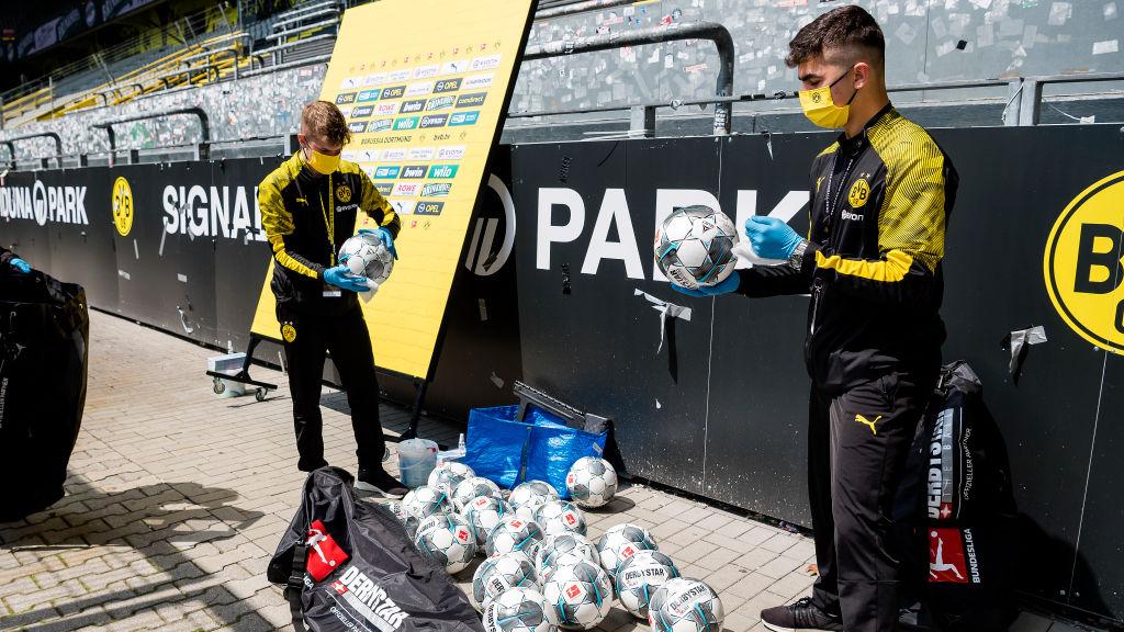 Bola untuk laga Borussia Dortmund vs Schalke 04 disemprot disinfektan.