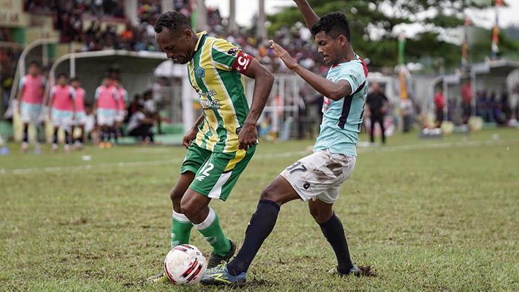 Pemain klub Liga 2 Sulut United, Ilham Fathoni (biru), mengawal pemain PSBS Biak