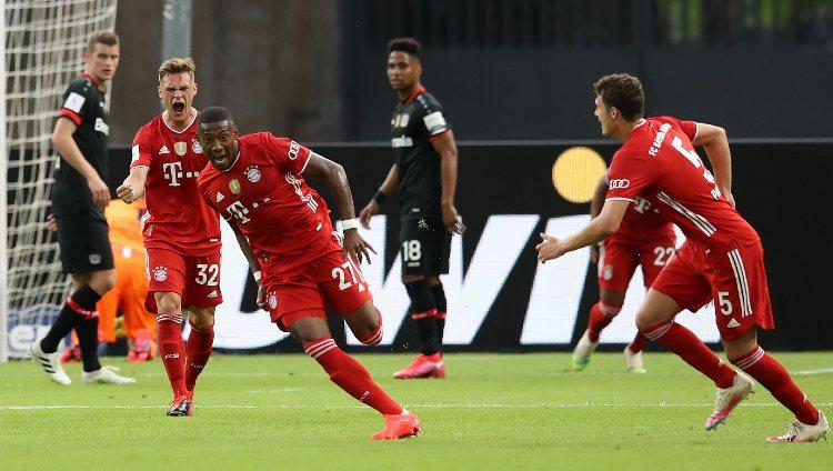 David Alaba (tengah) sumringah usai mencetak gol dalam laga Bayer Leverkusen vs Bayern Munchen di final DFB Pokal 2019-20, Minggu (05/07/20).