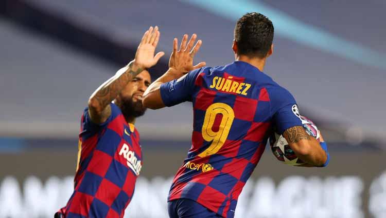 Selebrasi Luis Suarez dengan rekan setimnya Arturo Vidal usai mencetak gol untuk timnya dalam laga perempatfinal Liga Champions 2019/20.