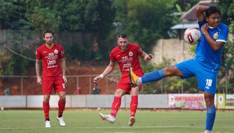 Tendangan bebas Marko Simic mendapat hadangan dari Adam Alis (kanan) pada uji coba antara Persija vs Bhayangkara, Rabu (22/09/20).