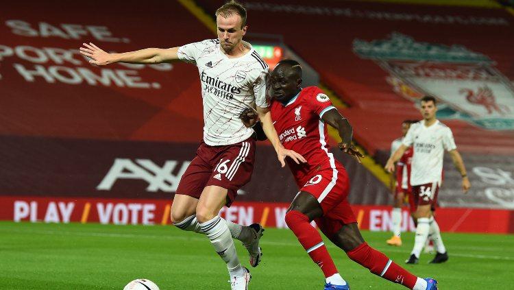 Sadio Mane dan Rob Holding berjibaku di laga Liverpool vs Arsenal, Selasa (29/09/20). Copyright: Andrew Powell/Liverpool FC via Getty Images