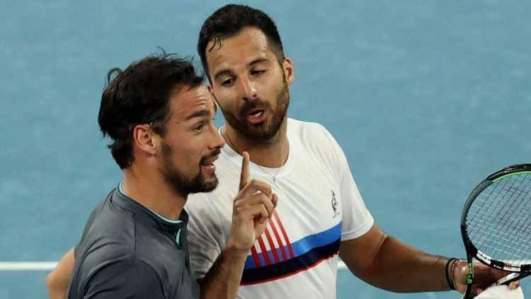 Selepas bertanding selama 3 jam 56 menit di putaran kedua Australian Open 2021, dua petenis Italia yakni Fabio Fognini dan Salvatore Caruso saling beradu mulut. - INDOSPORT