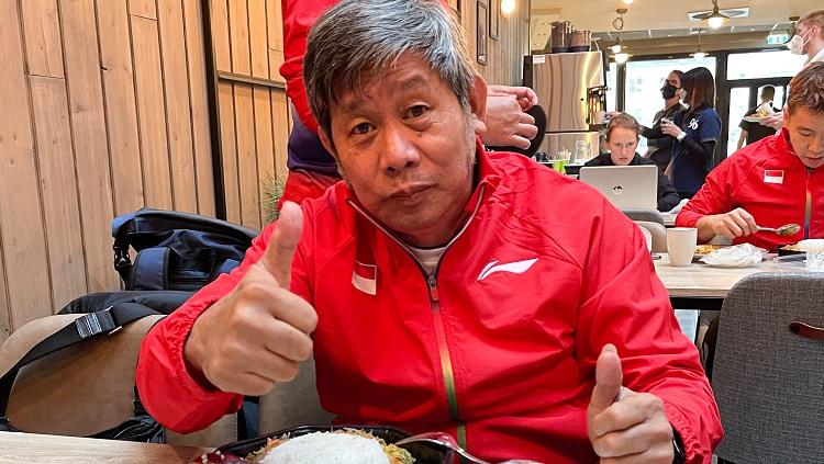 Sebuah reaksi kocak dilayangkan Mohammad Ahsan yang seolah kepanasan saat memergoki pelatihnya, Herry IP, dipepet Ketua Umum Bulutangkis China, Zhang Jun.