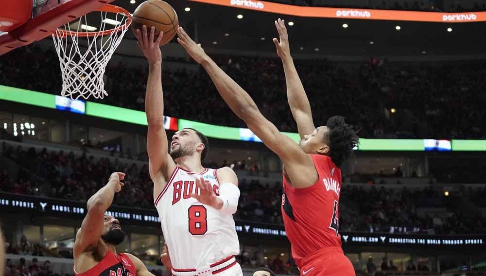 Pebasket Toronto Raptors, Scottie Barnes menahan serangan pebasket Chicago Bulls, Zach LaVine. Foto: Reuters/David Banks - INDOSPORT