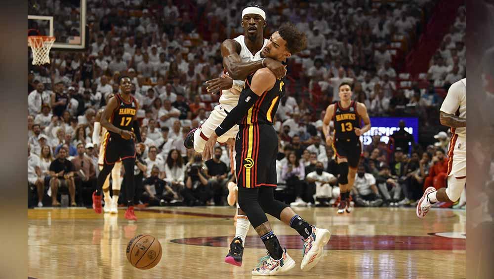 Pebasket Miami Heat, Jimmy Butler dan pebasket Atlanta Hawks, Trae Young saling bertabrakan di laga NBA antara Miami Heat vs Atlanta Hawks. Foto: REUTERS/Jim Rassol