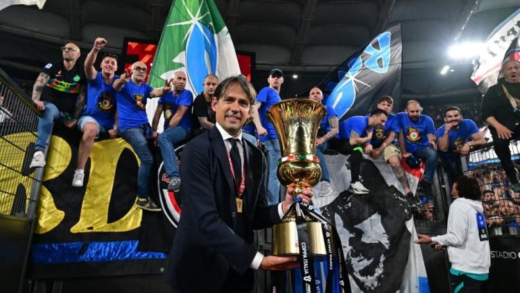Simone Inzaghi berpose dengan trofi Coppa Italia setelah bawa Inter Milan juara. Foto: REUTERS/Alberto Lingria. - INDOSPORT