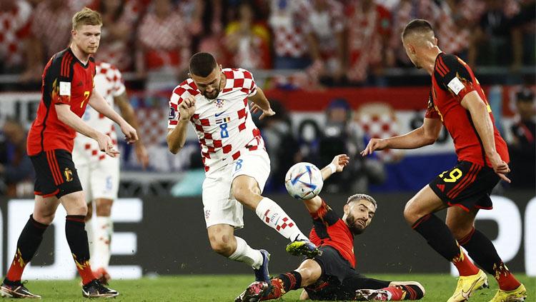 Perebutan antar pemain Kroasia vs Belgia dalam laga akhir Grup F Piala Dunia 2022 REUTERS/Stephane Mahe Copyright: REUTERS/Stephane Mahe