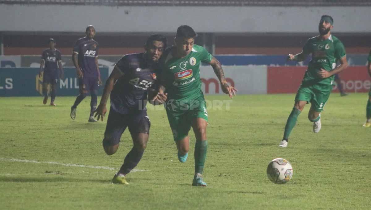 Gelandang PSS, Jonathan Cantillana berebut bola dengan bek Persik, Agil Munawar.