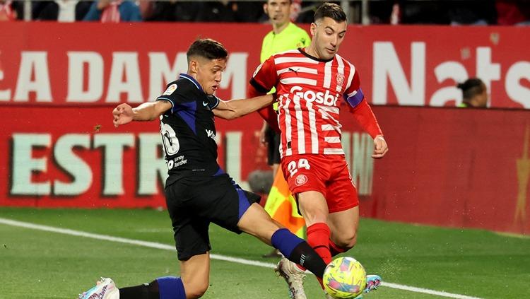 Nahuel Molina (kiri) berduel dengan Borja Garcia di laga Girona vs Atletico Madrid (14/03/23). (Foto: REUTERS/Nacho Doce)