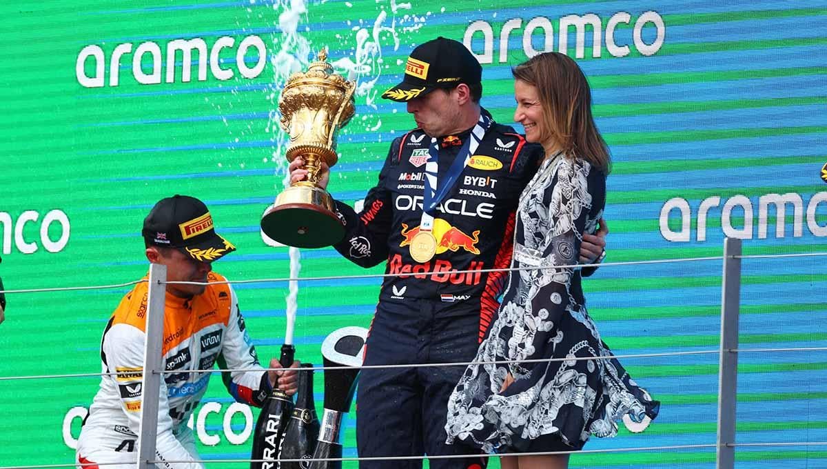Max Verstappen dan Lucy Frazer di podium setelah memenangkan balapan F1 GP Inggris di Sirkuit Silverstone, Inggris, Minggu (09/07/23). (Foto: REUTERS/Andrew Boyers)