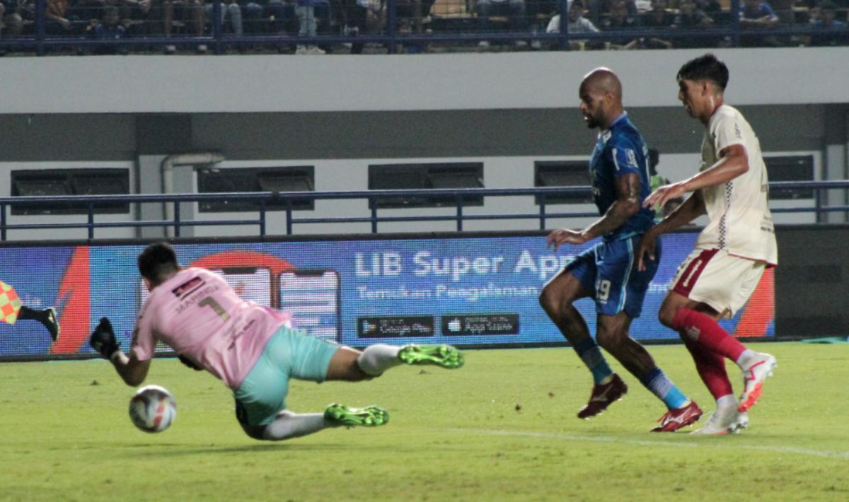 Kiper Bali United, Adilson Maringa (kiri) mengagalkan peluang striker Persib, David da Silva pada laga pekan keenam Liga 1 2023/2024 di stadion GBLA, Kamis (03/08/23).