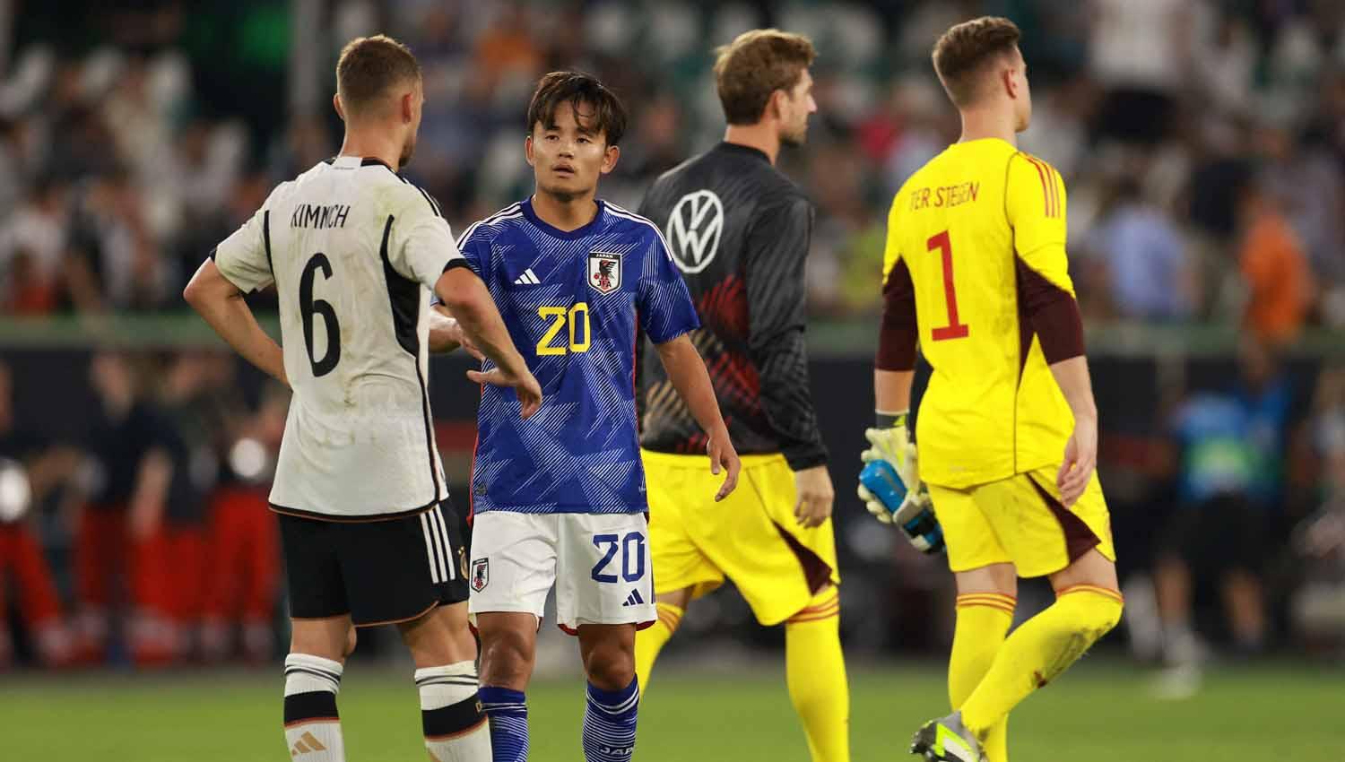 Pemain Jerman Joshua Kimmich saat berjabat tangan dengan pemain Jepang Takefusa Kubo setelah pertandingan. (Foto: REUTERS/Lisi Niesner)