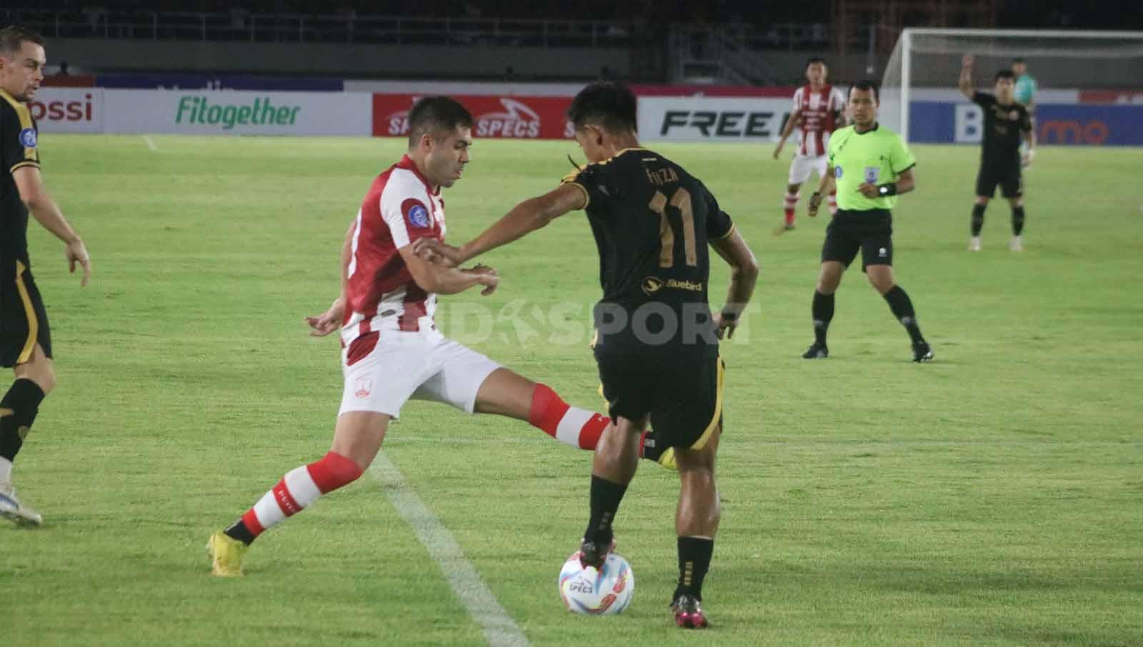 Penyerang Persis Solo, David Gonzalez, hendak merebut bolanyang dikuasai bek Persija, Firza Andika, dalam laga pekan ke-14 Liga 1 2023-2024, Sabtu (30/9/23). (Foto: Nofik Lukman Hakim/INDOSPORT)