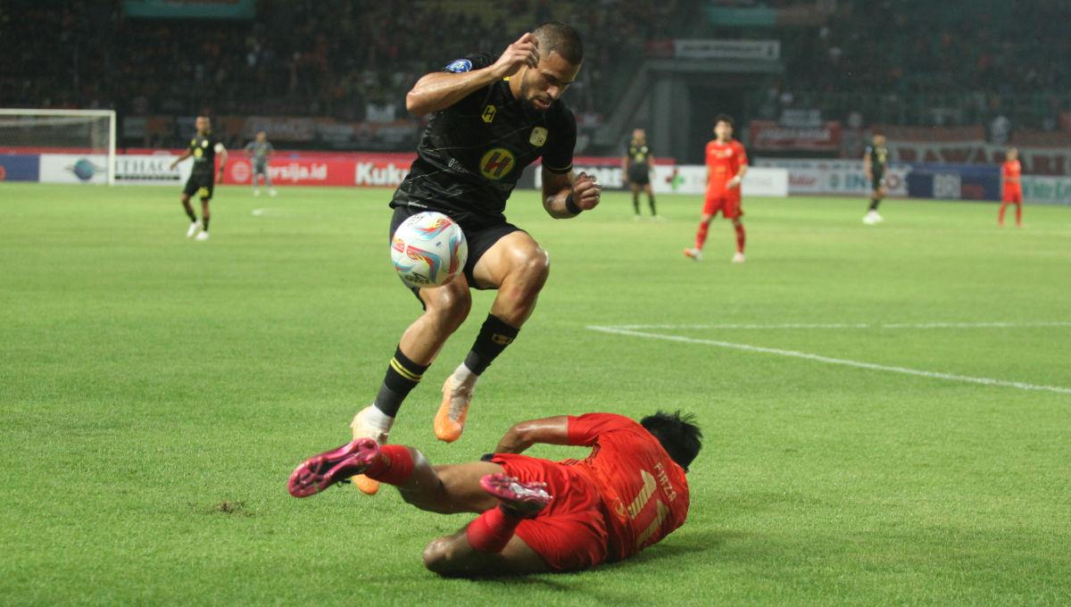 Striker Barito, Mike Otte menghindari tackle dari pemain Persija, Firza Andika dalam laga pekan ke-15 Liga 1 2023/2024 di Stadion Patriot, Minggu (07/10/23).