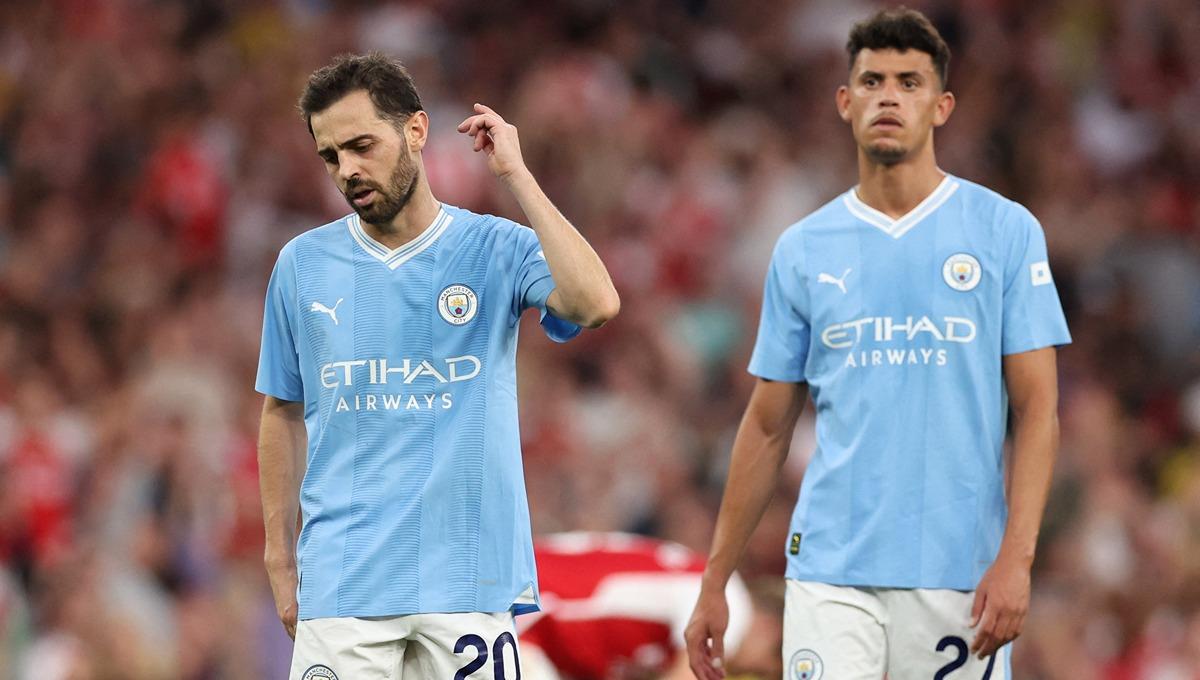 Ekspresi kecewa Bernardo Silva dan Matheus Nunes usai Manchester City tumbang dari Arsenal. (Foto: REUTERS/David Klein) - INDOSPORT
