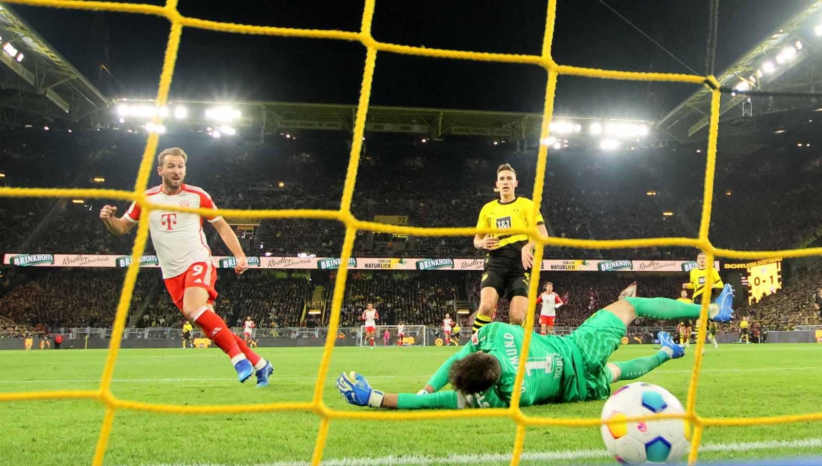 Harry Kane mencetak gol kedua saat berhadapan dengan kiper Borussia Dortmund Gregor Kobel pada laga Bundesliga Jerman di Stadion Signal Iduna Park. (Foto: REUTERS/Wolfgang Rattay)