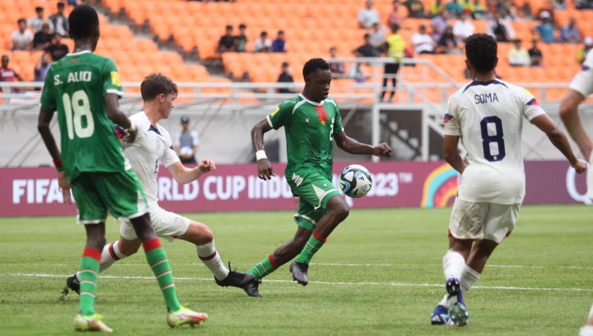 Pemain Burkina Faso, Emmanuel Jamison mencoba melakukan tembakan ke gawang Amerika Serikat pada laga kedua fase grup E Piala Dunia U-17 2023 di Stadion JIS, Rabu (15/11/23).