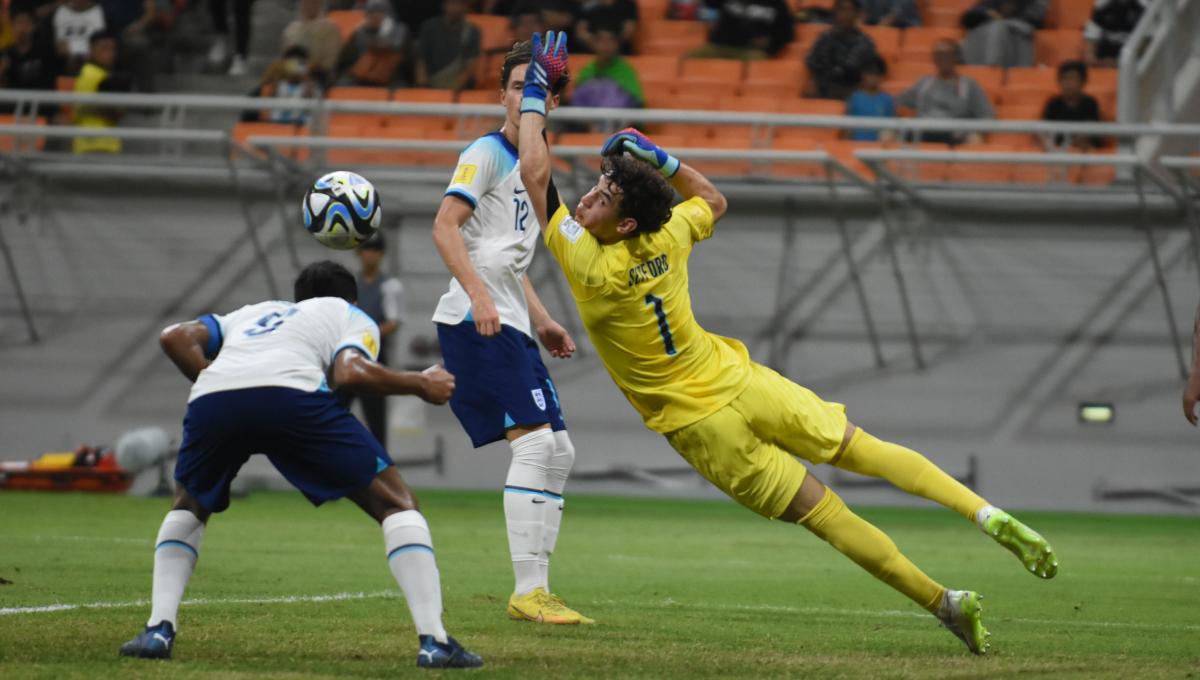 Kiper Inggris, Tommy Setford mencoba mengahalau bola yang mengarah ke gawangnya pada laga ketiga fase grup C Piala Dunia U-17 2023 melawan Brasil di Stadion JIS, Jumat (17/11/23).