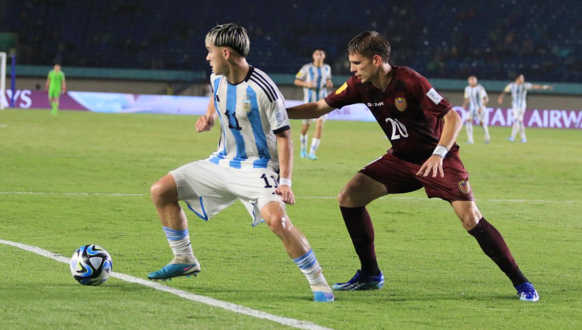 Striker Timnas Argentina U-17, Lopez Santiago, dibayang-bayangi bek Timnas Venezuela U-17, Balbo Luis pada babak 16 besar Piala Dunia U-17 2023 di Stadion Si Jalak Harupat, Kabupaten Bandung, Selasa (21/11/23). (Arif)