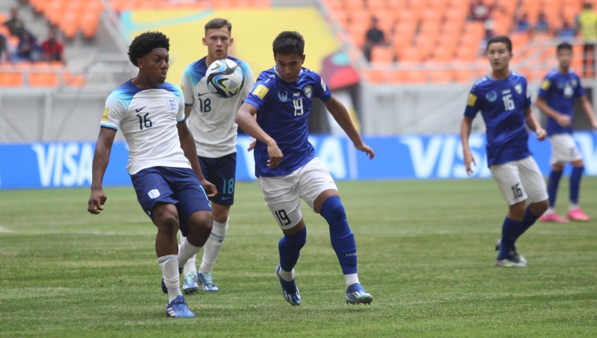 Pemain Uzbekistan, Sherzodbek AbdulBoriev mencoba melewati pemain Inggris, Myles Lewis-Skelly pada laga 16 besar Piala Dunia U-17 2023 di Stadion JIS, Rabu (22/11/23).