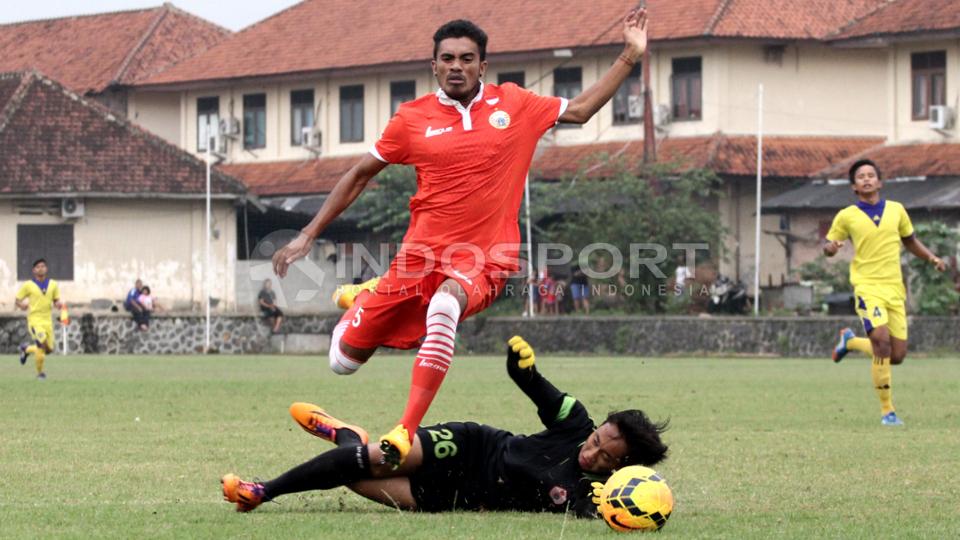 Pemain Persija Jakarta Alfin Tuasalamony dijatuhkan kiper Pra-PON DKI Jakarta dalam laga uji coba di Lapangan Mako Brimob, Depok, Rabu (25/03/15). Copyright: Herry Ibrahim/INDOSPORT