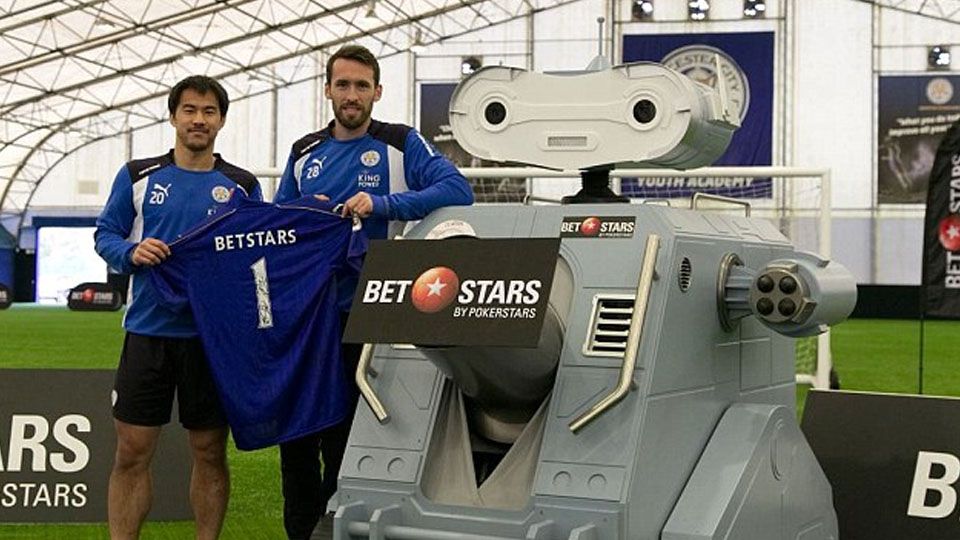 Dua pemain Leicester City, Christian Fuchs, Shinji Okazaki dan sebuah robot. Copyright: © dailymail.co.uk