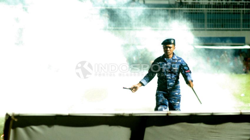 Petugas keamanan mengamankan smoke bomb yang dileparkan pendukung Persiba Bantul. Copyright: &copy; Prima Pribadi/INDOSPORT