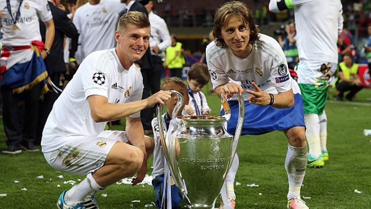 Toni Kroos (kiri) dan Luka Modric pose bersama trofi Liga Champions. Copyright: © Chris Brunskill Ltd/Getty Images
