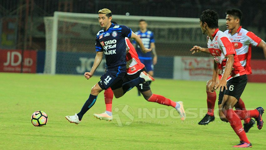 Tiga pemain Madura United coba menghentikan agresifitas Esteban Vizcarra Copyright: © Ian Setiawan/Soicaumienbac.cc