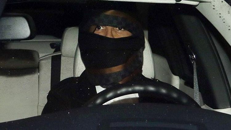 Cristiano Ronaldo menggunakan masker saat keluar dari restoran. Copyright: © Getty Images.