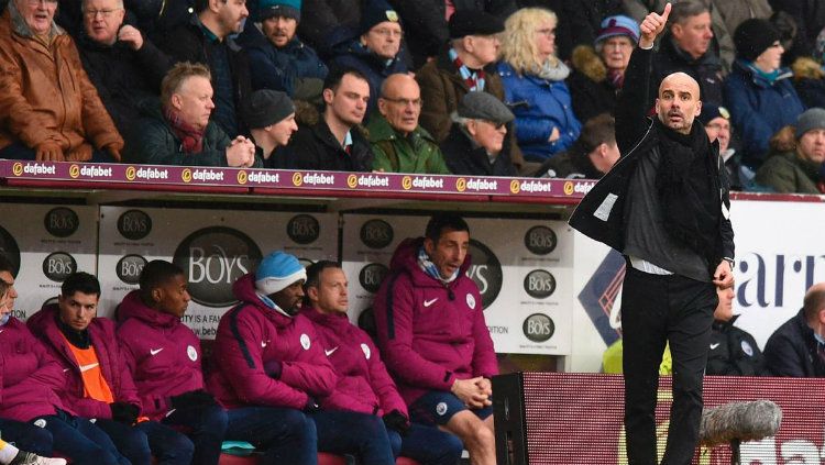 Manajer Manchester City Pep Guardiola saat memberikan instruksi kepada anak asuhnya di pinggir lapangan. Copyright: © Getty Images