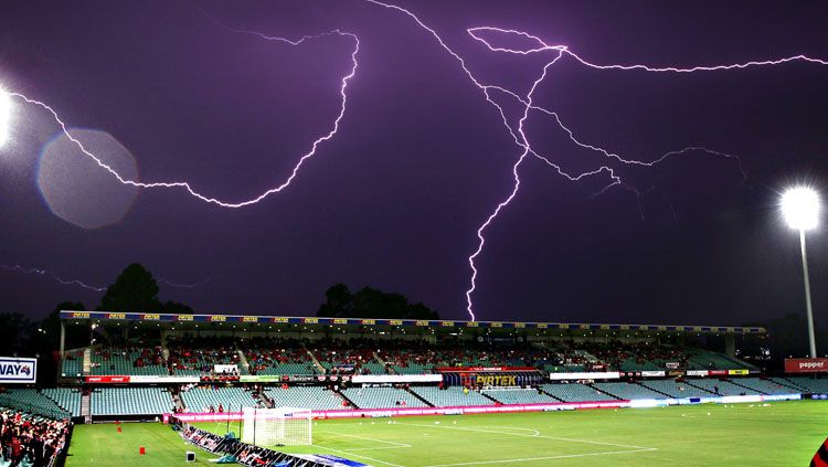 Ilustrasi sambaran petir di stadion sepakbola. Copyright: © Getty Images