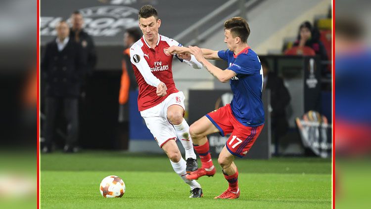 Bek tengah Arsenal, Laurent Koscielny (kiri) berduel dengan gelandang serang CSKA Moskow, Aleksandr Golovin. Copyright: © Getty Images