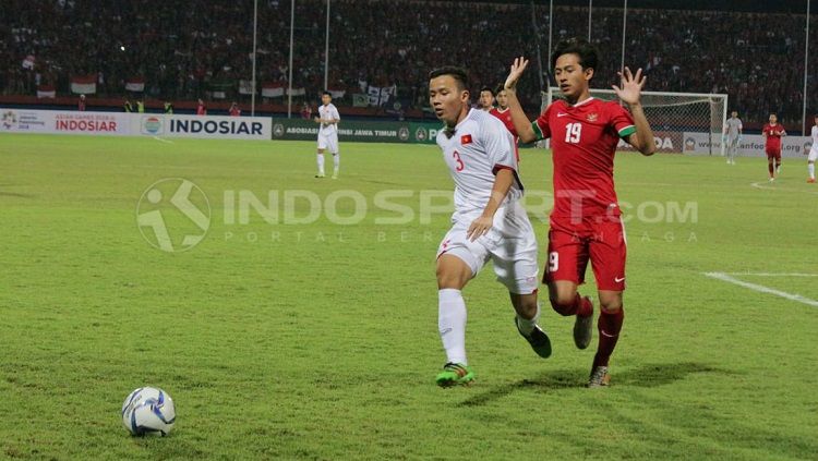 Hanis Saghara berebut bola dengan Nguyen Hung Thien. Copyright: © Fitra Herdian/INDOSPORT