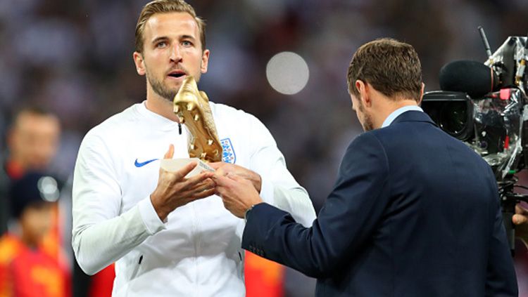 Harry Kane saat pamerkan penghargaan sepatu emas Piala Dunia 2018 yang kemudian membawanya meraih gelar MBE dari kerajaan Inggris. Copyright: © Getty Images