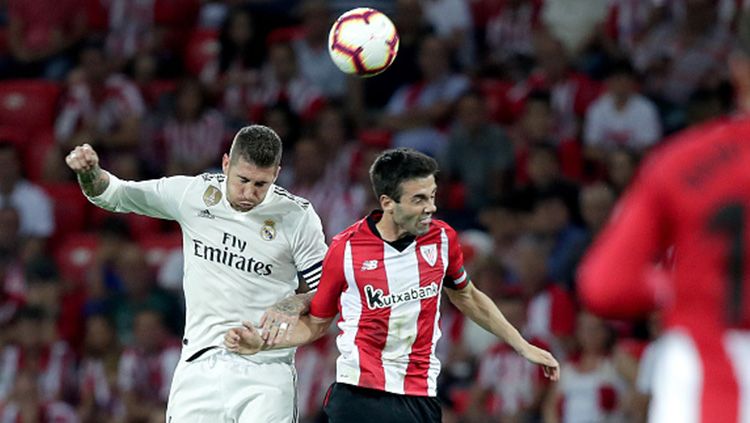 Duel udara Sergio Ramos dengan pemain Athletic Bilbao. Copyright: © Soccrates Images