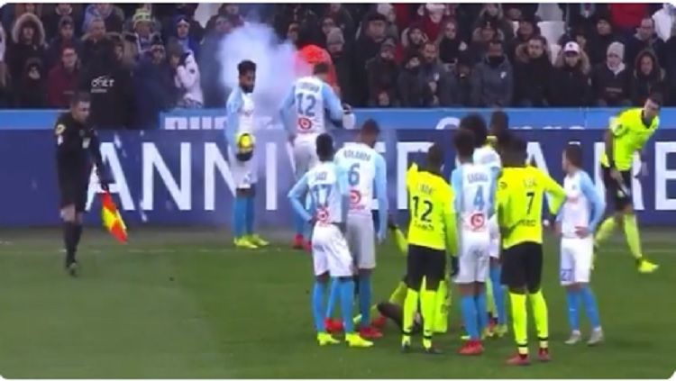 Pemain Olympique Marseille hampir terkena serangan kembang api dari tribune penonton. Copyright: © Twitter/@Ssamax