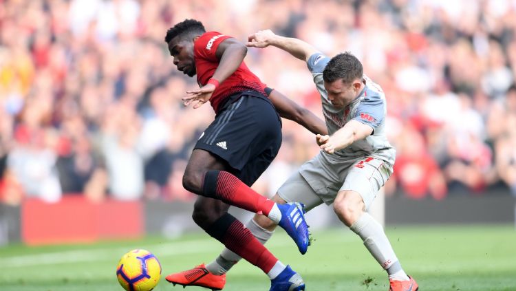 Paul Pogba berduel dengan James Milner. Copyright: © Getty Images/Laurence Griffiths