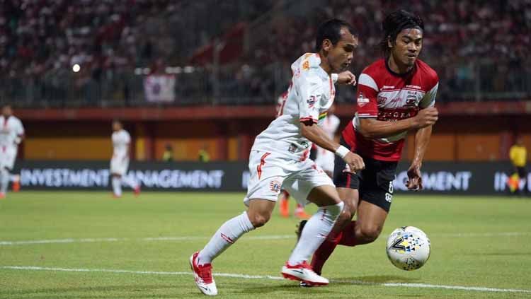 Duel pemain Persija, Riko Simanjuntak dengan pemain Madura United pada pertandingan antara Madura United vs Persija Jakarta, Jumat (16/08/19). Copyright: © Media Persija