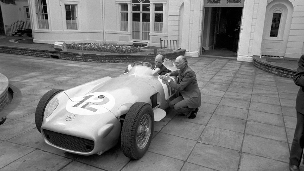Sir Stirling Craufurd Moss (duduk di mobil), legenda terbaik F1 dikabarkan meninggal dunia. Copyright: © PA Images via Getty Images