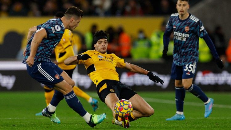 Raul Jimenez (tengah) berduel dengan Granit Xhaka di laga Wolves vs Arsenal (11/02/22). (Foto: Reuters/Jason Cairnduff) Copyright: © Reuters/Jason Cairnduff