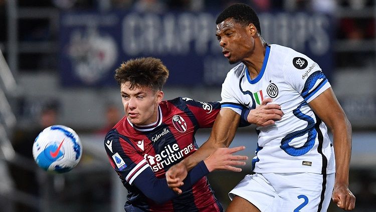 Bek Bologna Aaron Hickey berduel dengan bek InterMilan, Denzel Dumfries (REUTERS/Jennifer Lorenzini) Copyright: © REUTERS/Jennifer Lorenzini