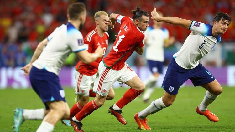 Wales vs Inggris di Piala Dunia 2022 tidak hanya menyajikan hiburan saja bagi para penontonnya namun juga melahirkan sejumlah catatan unik. (Foto: REUTERS/Hannah Mckay). Copyright: © REUTERS/Hannah Mckay