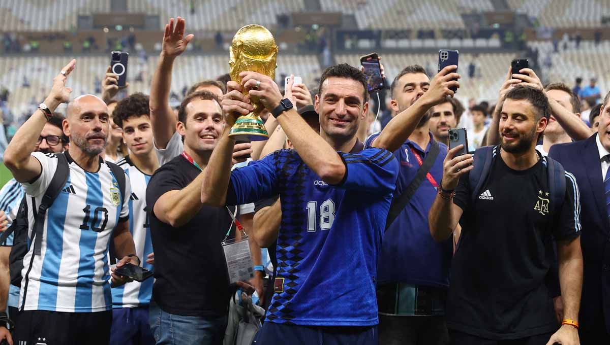 Lionel Scaloni berfoto dengan trofi Piala Dunia 2022 usai bawa Timnas Argentina juara. Foto: REUTERS/Hannah Mckay. Copyright: © REUTERS/Hannah Mckay