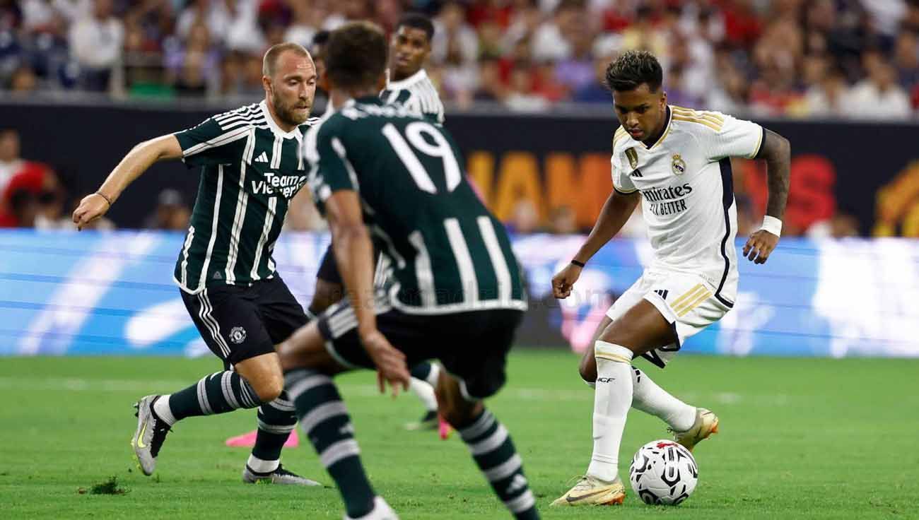 Pemain Real Madrid, Rodrygo mendapat kawalan pemain Manchester United Christian Eriksen di laga pramusim. (Foto: realmadrid) Copyright: © realmadrid