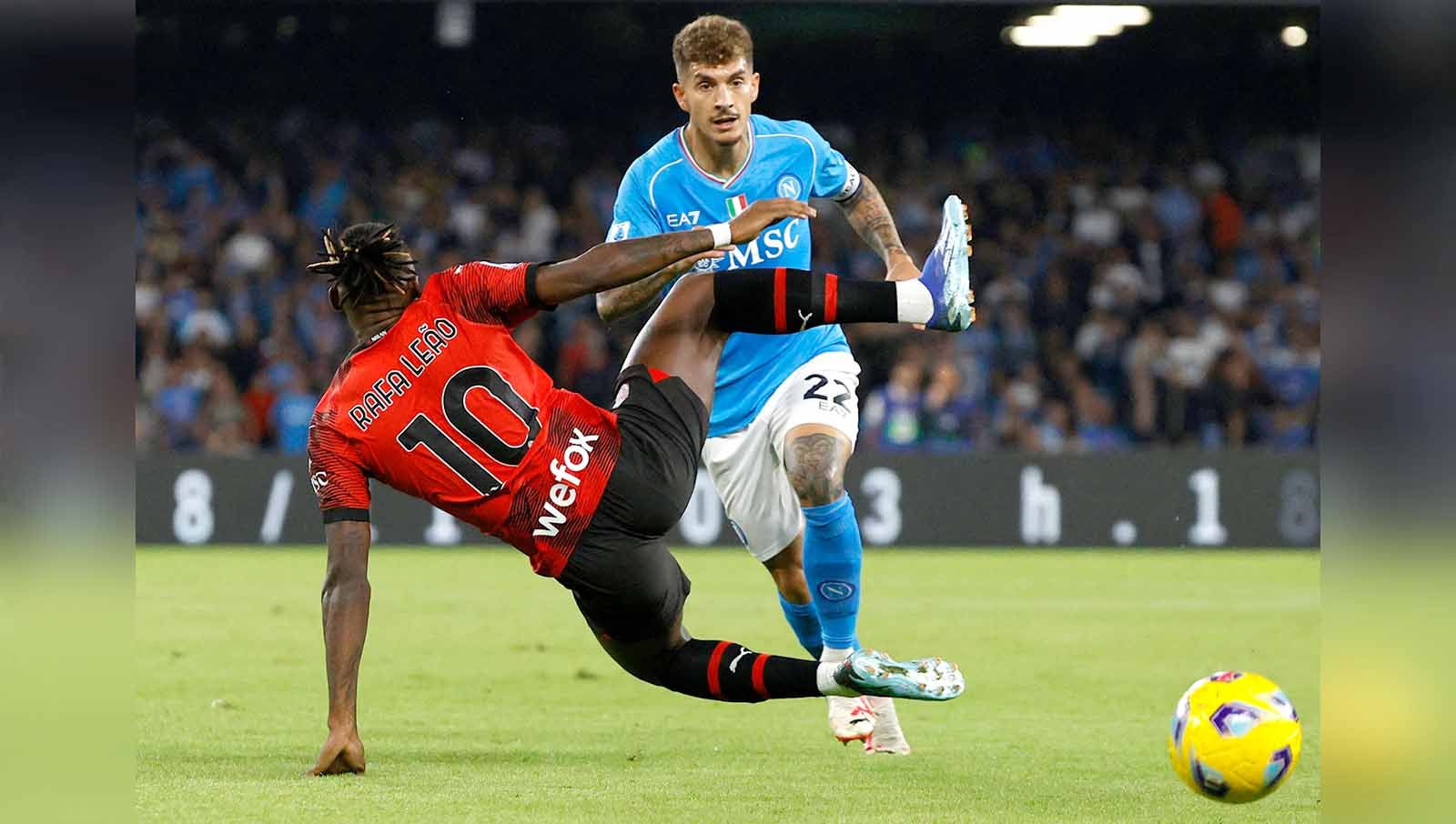 Pemain AC Milan Rafael Leao berusaha menghalangi pergerakan pemain Napoli Giovanni Di Lorenzo. (Foto: REUTERS/Ciro De Luca) Copyright: © REUTERS/Ciro De Luca